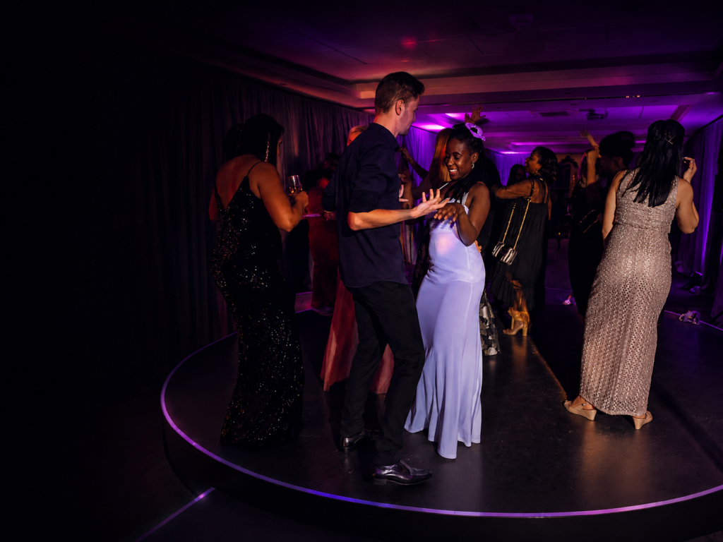 Peter Styla DJing at a Toronto corporate event with guests dancing under purple lighting