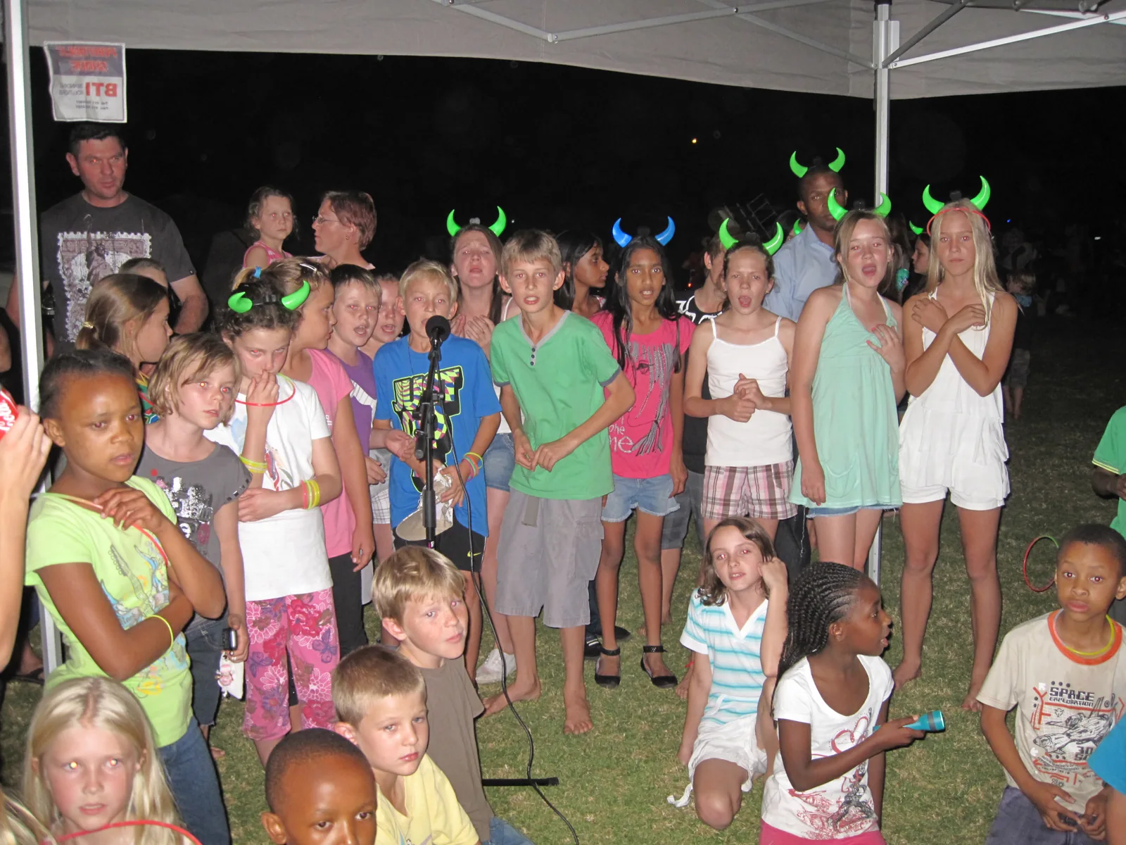 A group taking part in karaoke at a school camp-out